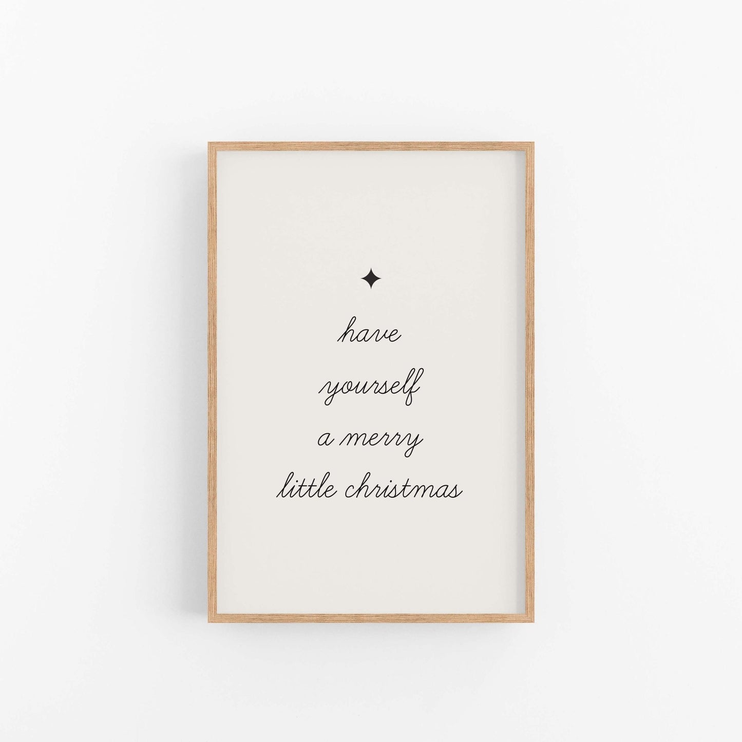 Framed artwork with 'have yourself a merry little Christmas' text on a white background