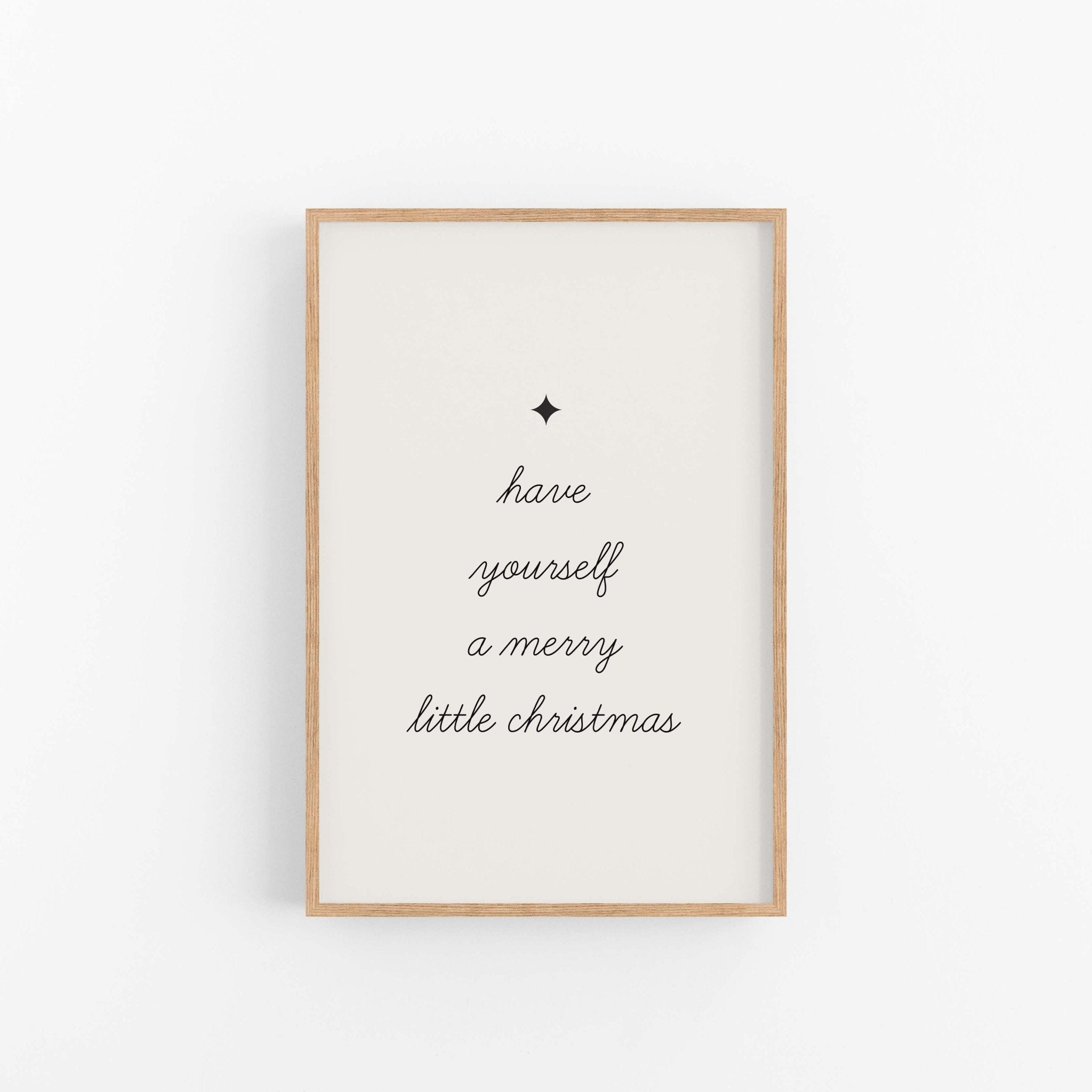 Framed artwork with 'have yourself a merry little Christmas' text on a white background