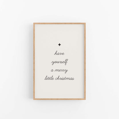 Framed artwork with 'have yourself a merry little Christmas' text on a white background