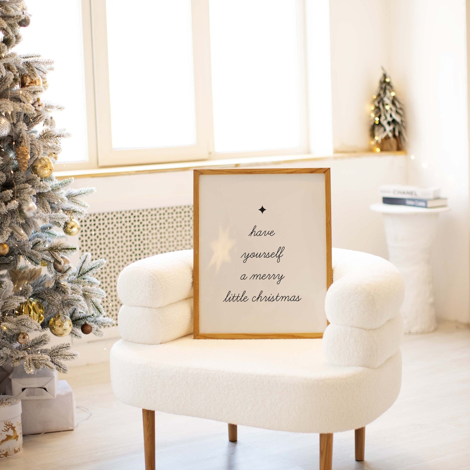 White armchair with a framed Christmas message in a room decorated for Christmas.