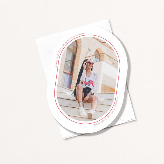 Minimal Geo graduation announcement card with oval photo cutout showing grad sitting on steps, with personalized name and school details