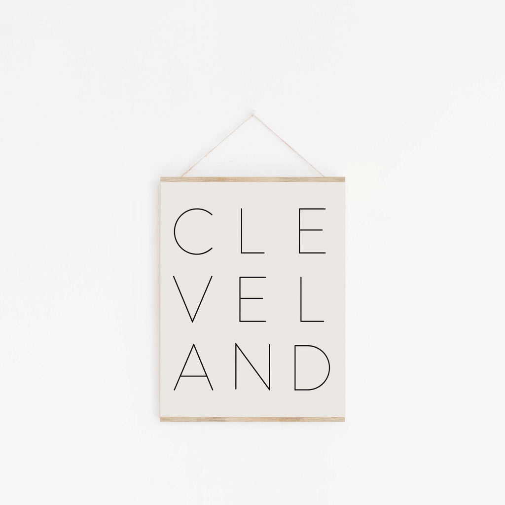 Cleveland typography wall art hanging from wood hanger with minimalist design