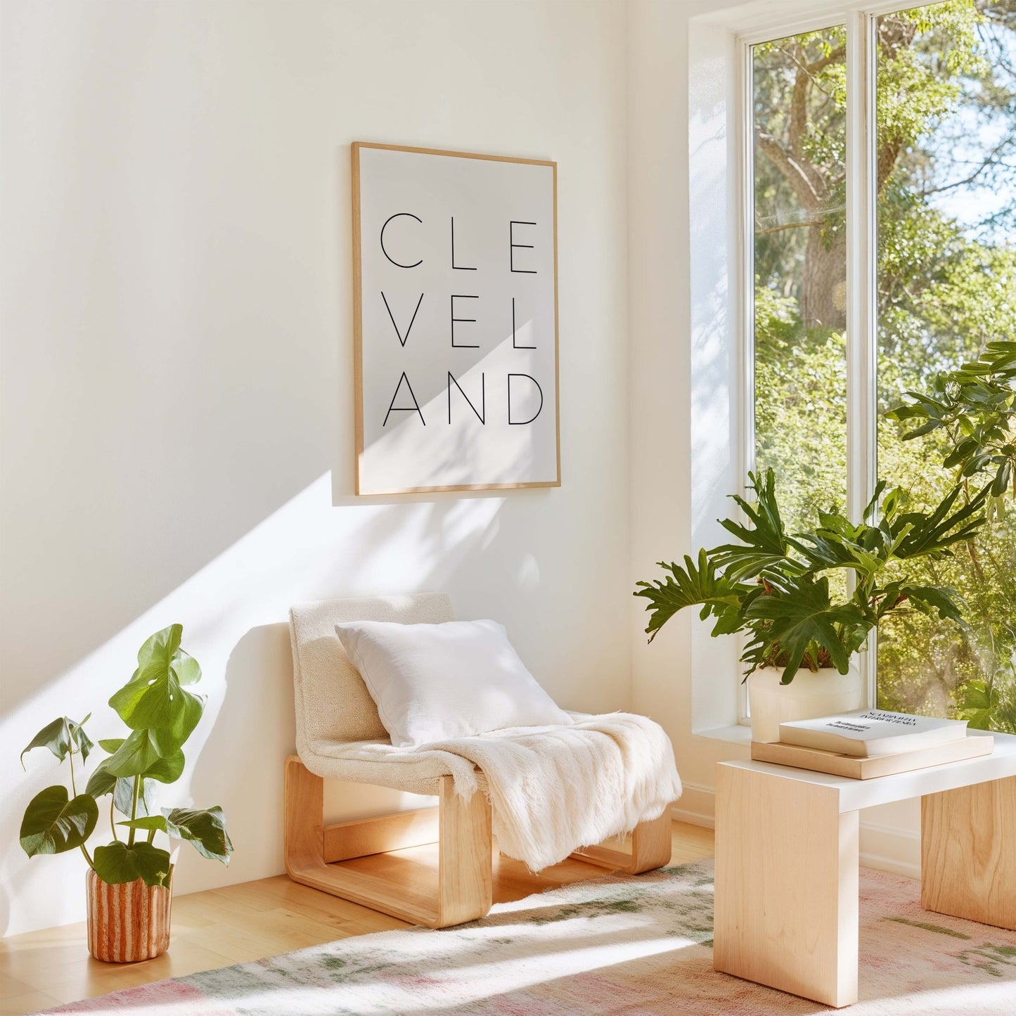 Cleveland typography wall art styled in modern living room with neutral decor and plants