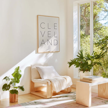 Cleveland typography wall art styled in modern living room with neutral decor and plants