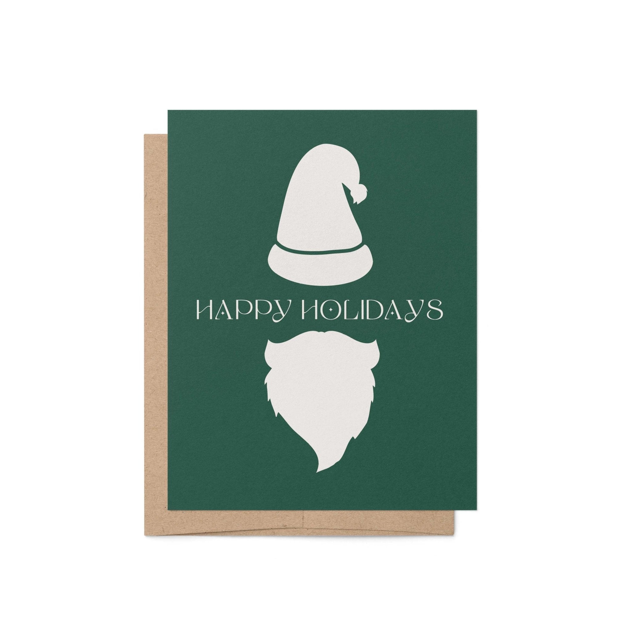 Modern Santa holiday greeting card with minimalist white hat and beard on green background, paired with kraft envelope