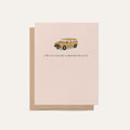 Blush pink greeting card featuring a illustrated faux gold minivan with the text 'Only you can make a minivan look good,' displayed with a kraft brown envelope on a light neutral background.