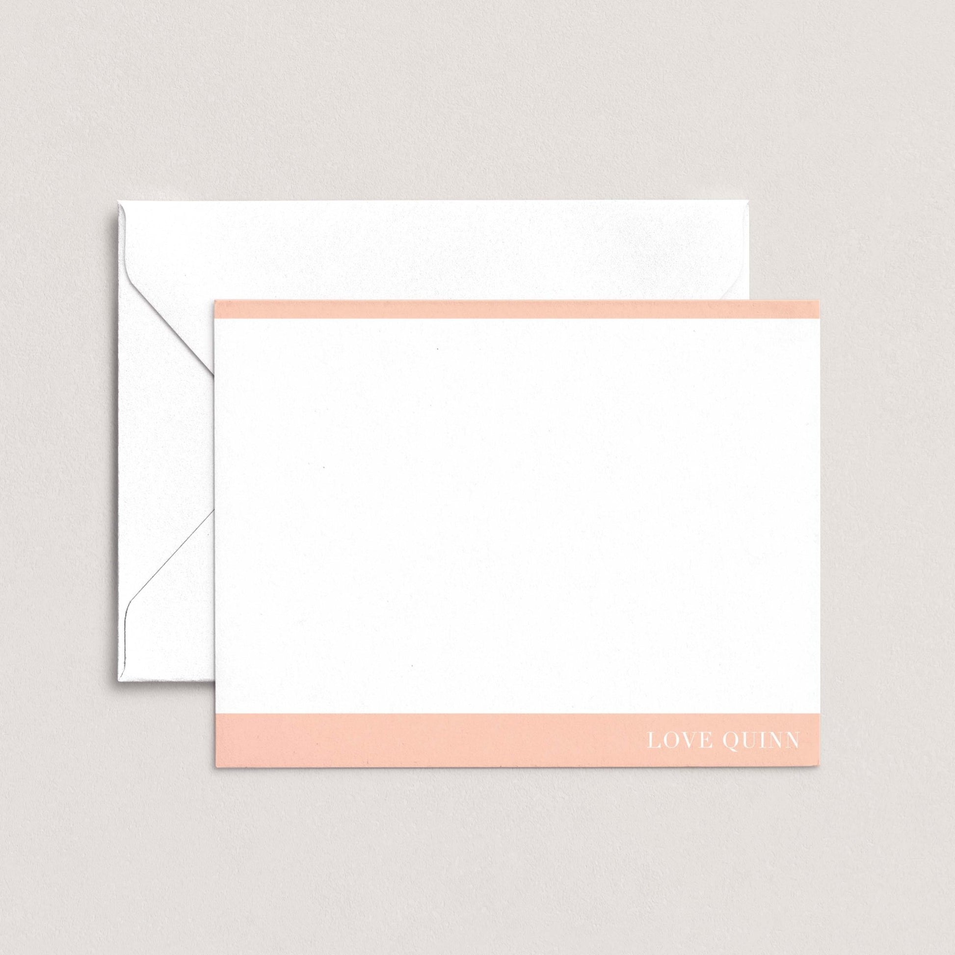 A white envelope with a pink stripe and a blank white card with the text "LOVE QUI'N" printed on it.