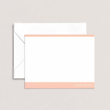 A white envelope with a pink stripe and a blank white card with the text "LOVE QUI'N" printed on it.
