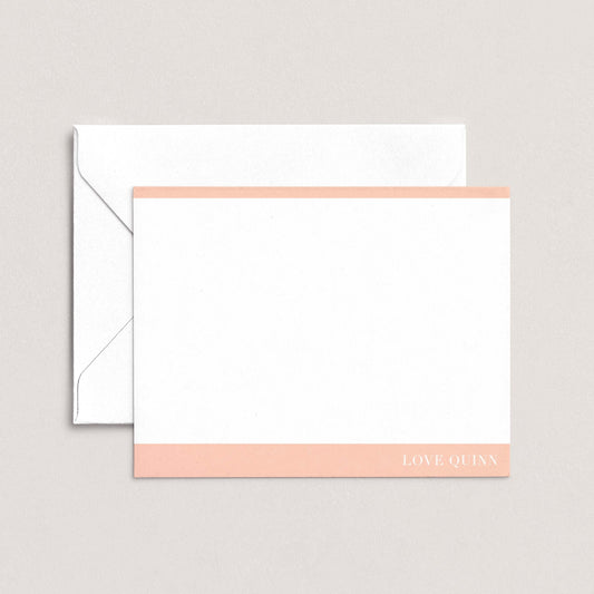 A white envelope with a pink stripe and a blank white card with the text "LOVE QUI'N" printed on it.