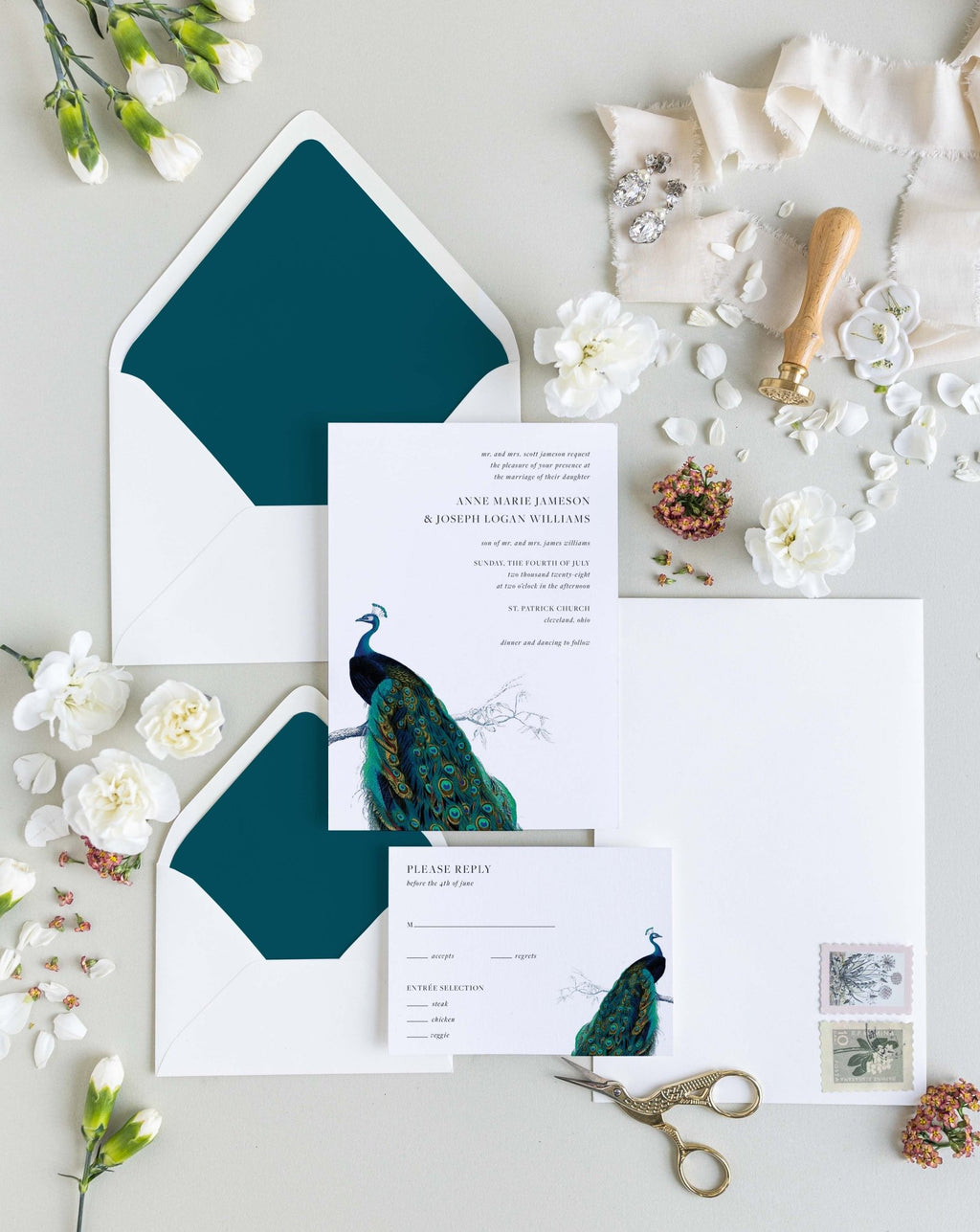 Modern Peacock wedding invitation suite by Blú Rose, invitation and reply card with a vintage peacock illustration, styled with teal-lined envelopes, ribbon, and a wax seal