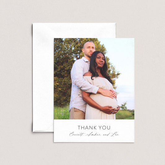 A couple embracing in a field, with the text "Thank you" and "Cerell, Amber, and Leo" below the photo.