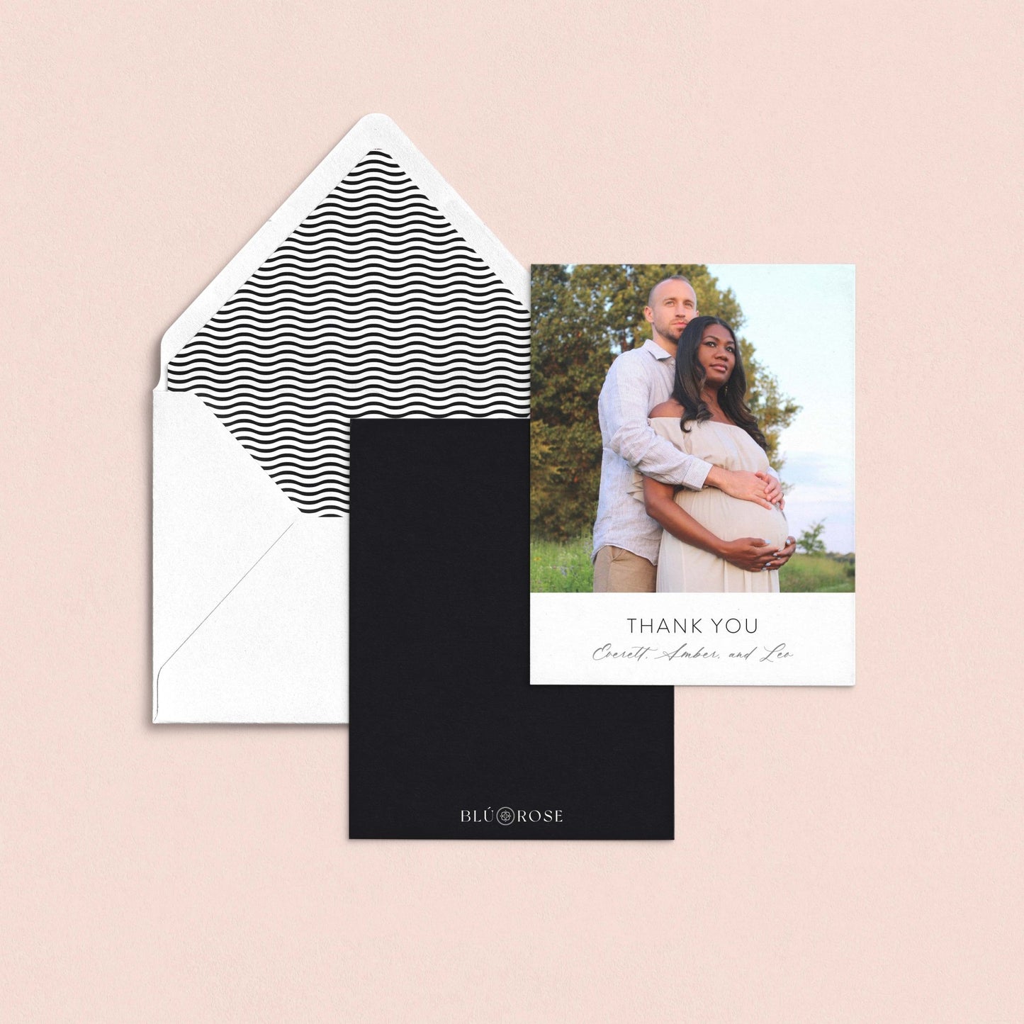 a couple posing for a photograph, with a "Thank You" card placed below the photo.