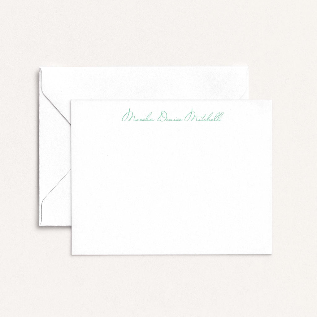 Moesha personalized notecards by Blú Rose, white flat notecard with the name 'Moesha Denise Mitchell' in green script, shown with a white envelope