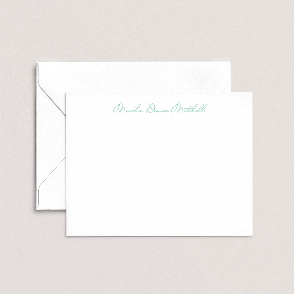 Moesha personalized notecards by Blú Rose, white flat notecard with the name 'Moesha Denise Mitchell' in green script, shown with a coordinating white envelope