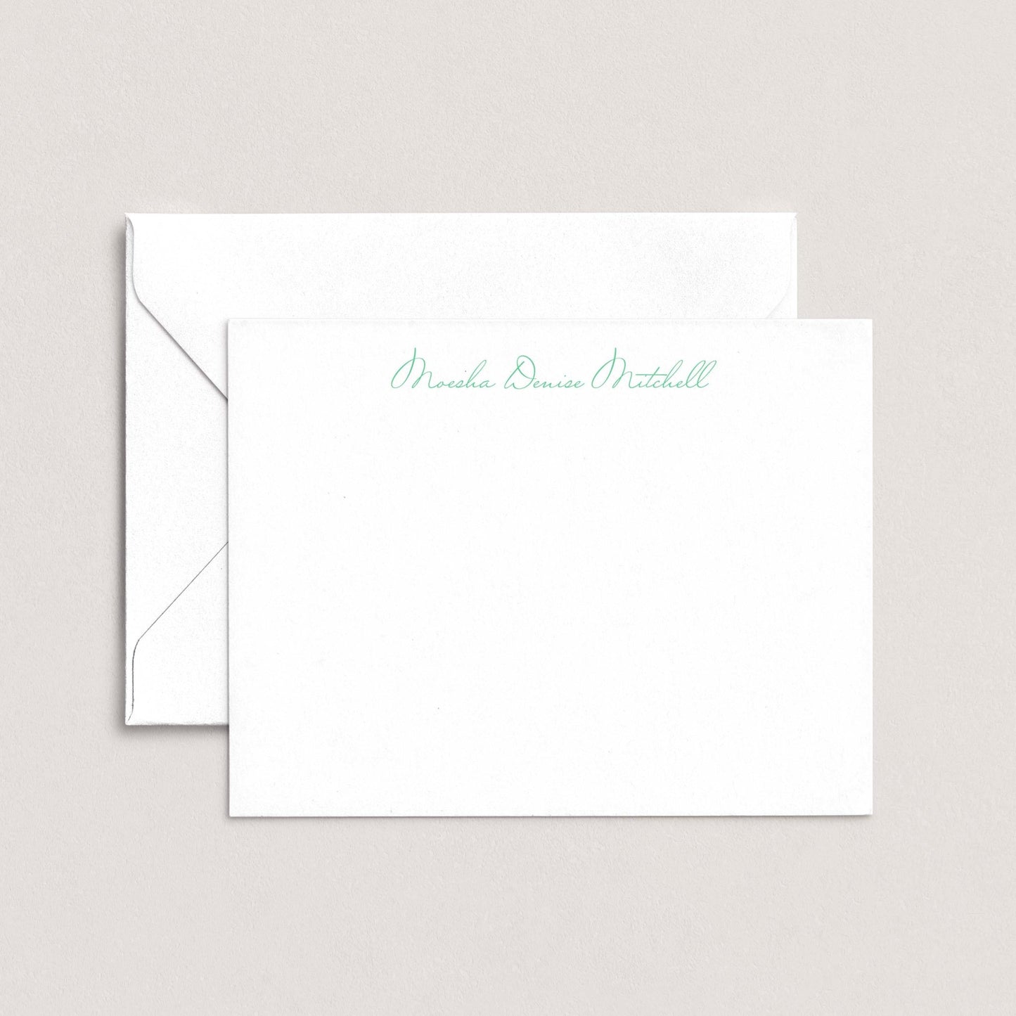 A white envelope with a personalized note inside, placed on a plain background.