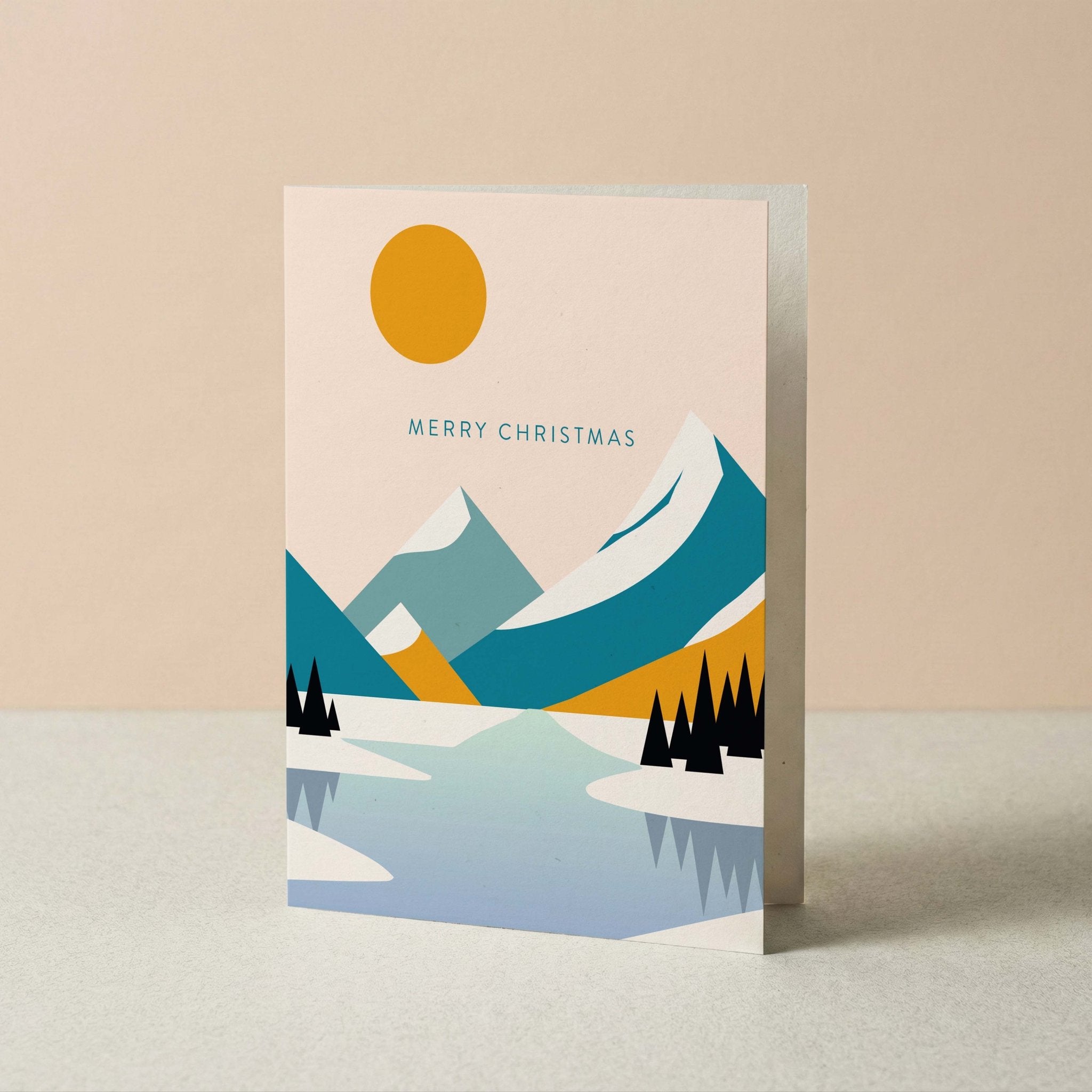 Mountain Landscape Merry Christmas card by Blú Rose standing upright, modern mountain and lake illustration on a neutral background