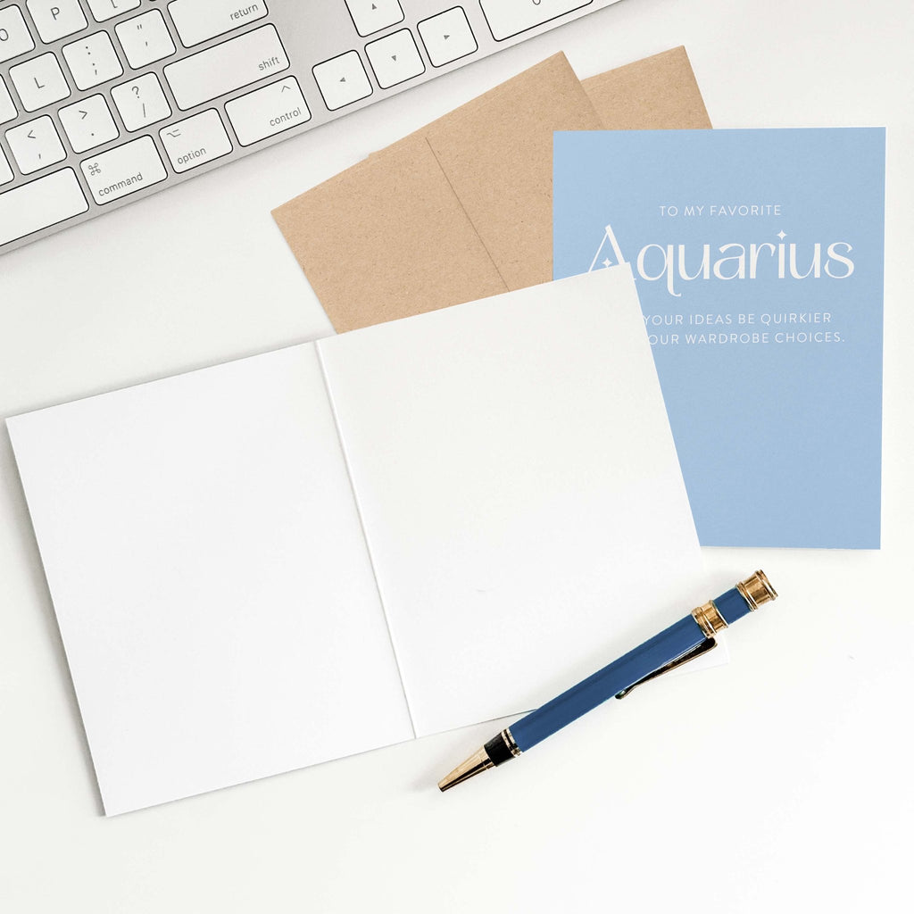 Aquarius birthday card with open blank interior, envelope, and pen