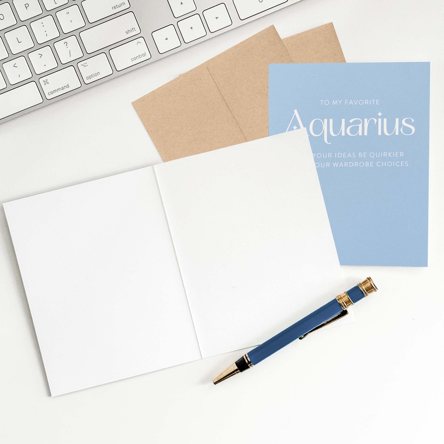 Aquarius birthday card with open blank interior, envelope, and pen