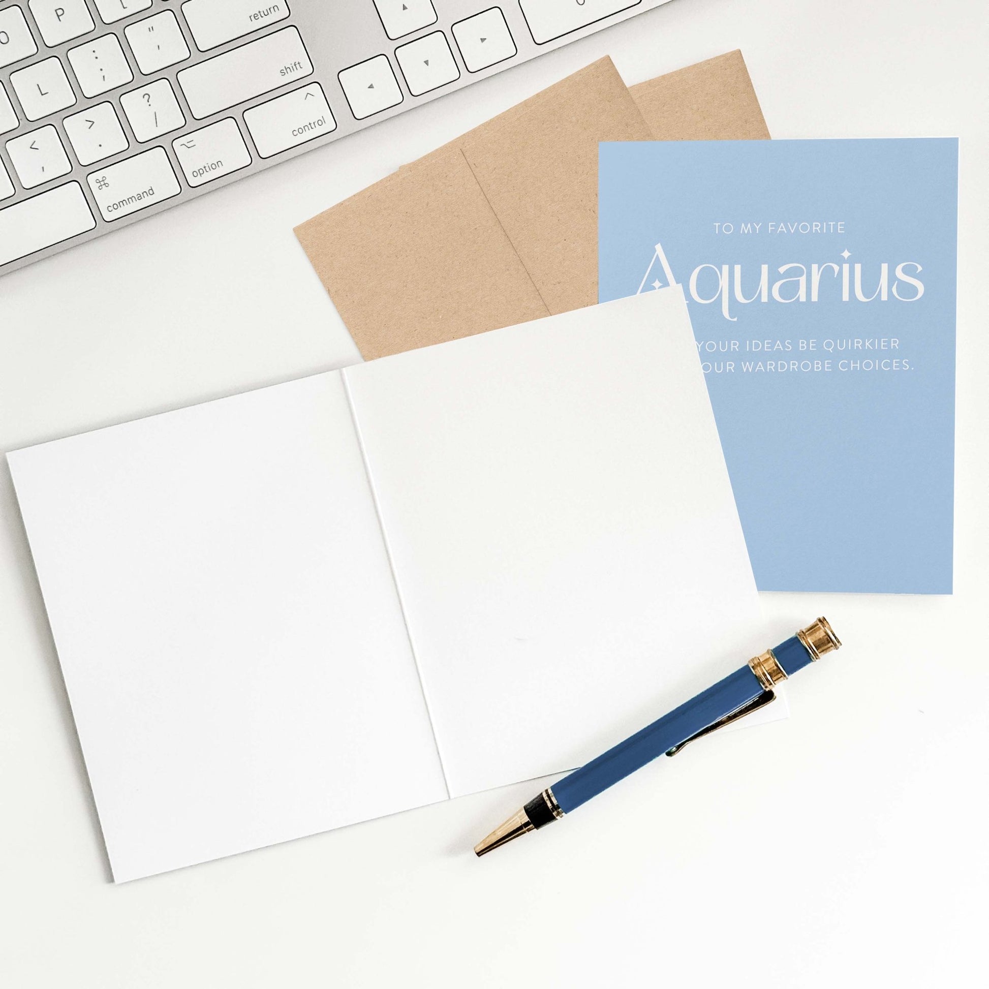 Aquarius birthday card with open blank interior, envelope, and pen