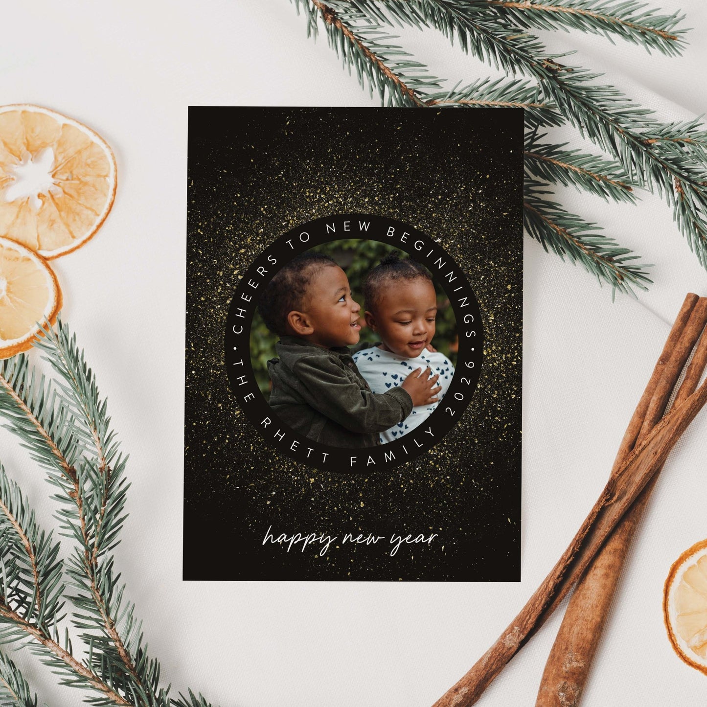 New Year Sparkle holiday photo card styled with greenery and citrus accents