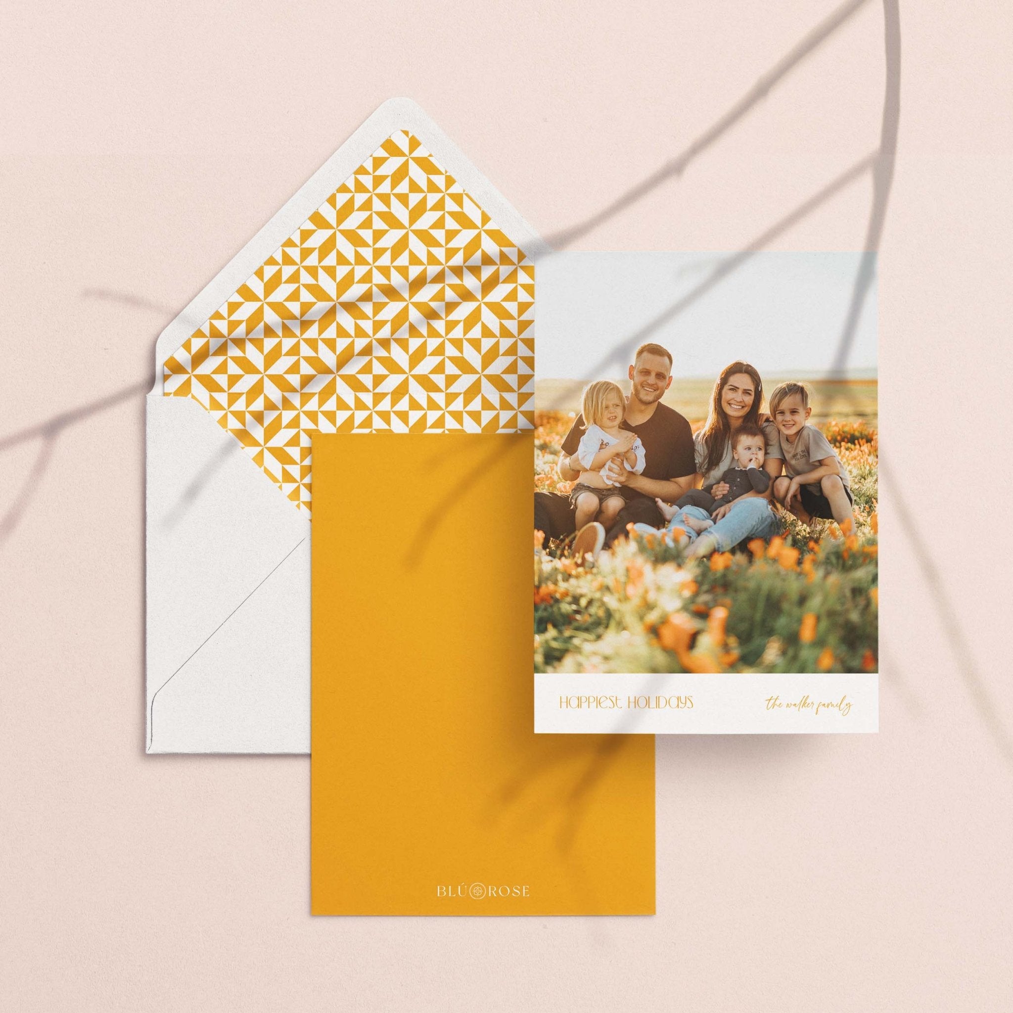 On the Edge card with its golden lattice-print envelope liner styled on a blush backdrop
