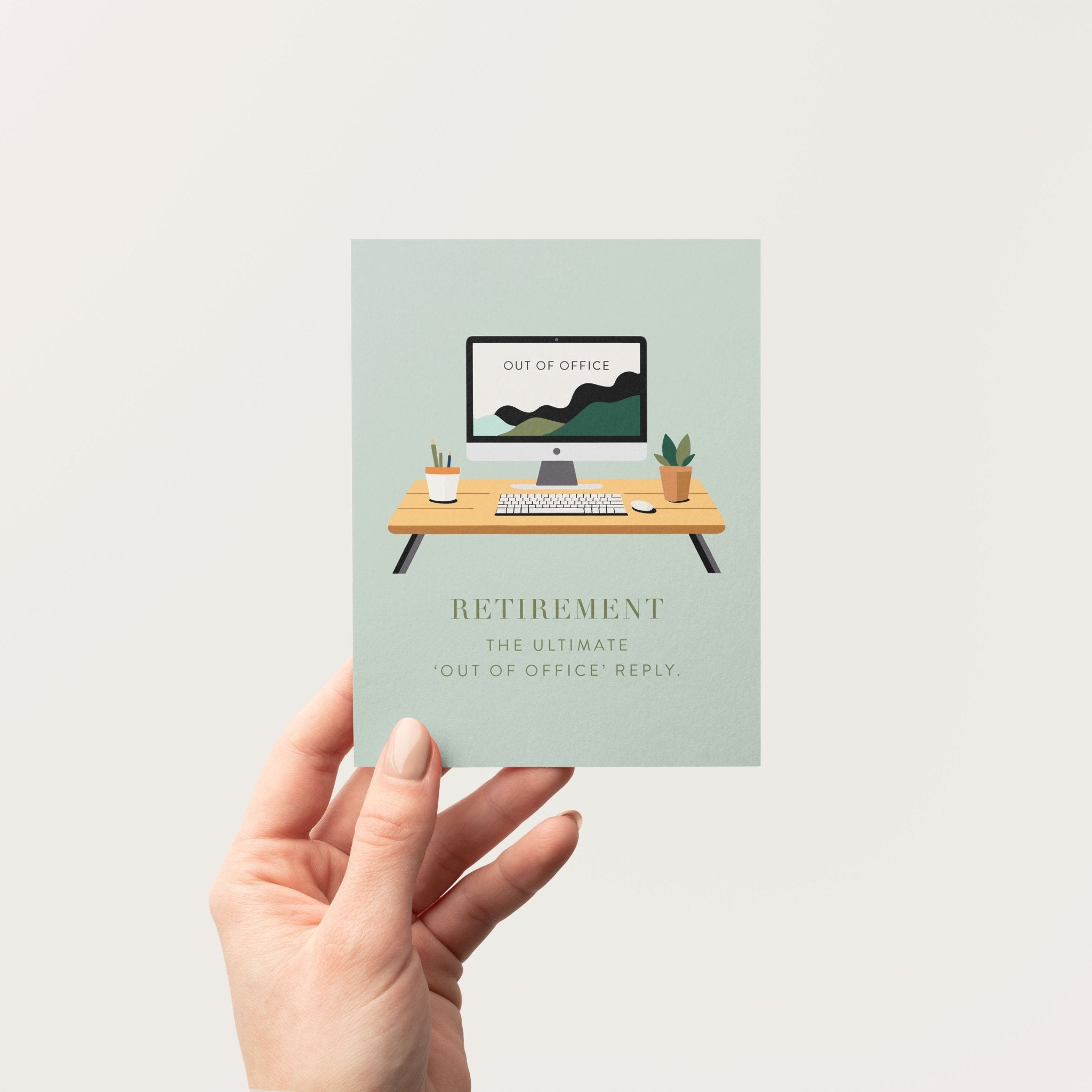 Person holding retirement greeting card in front of a neutral background.