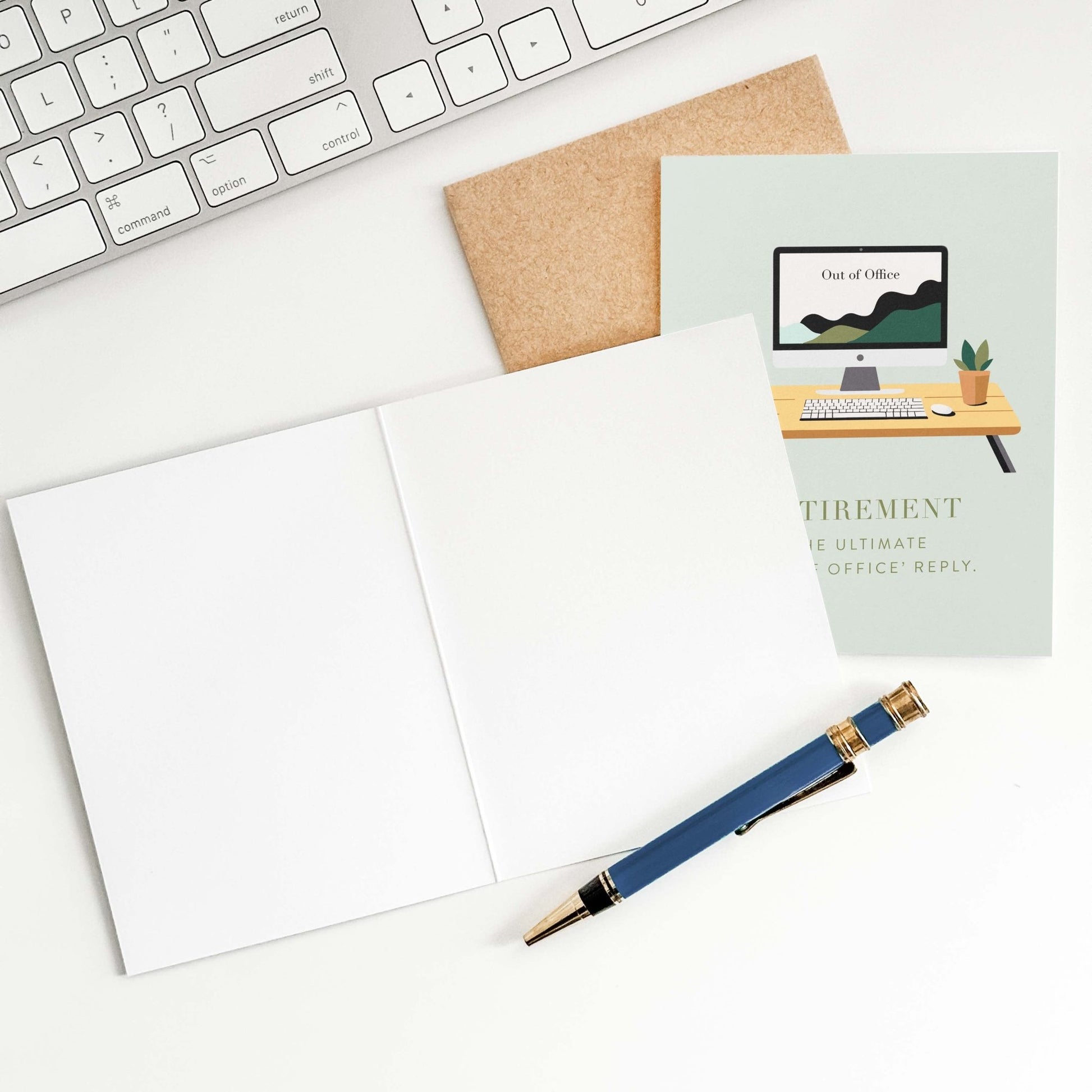 Flatlay of retirement greeting card with open kraft envelope and pen on white desk with keyboard.