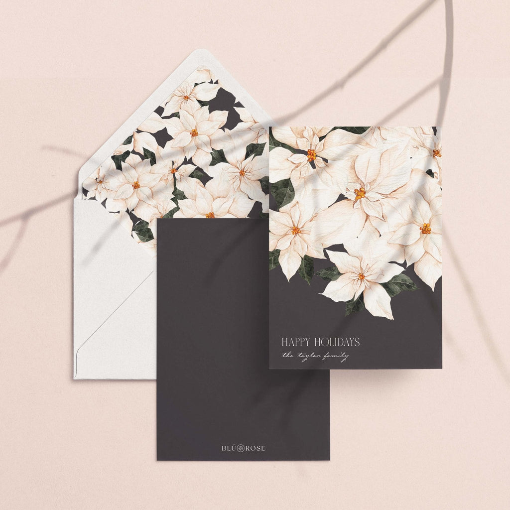 Perfect Poinsettia card with its white poinsettia envelope liner styled on a blush backdrop