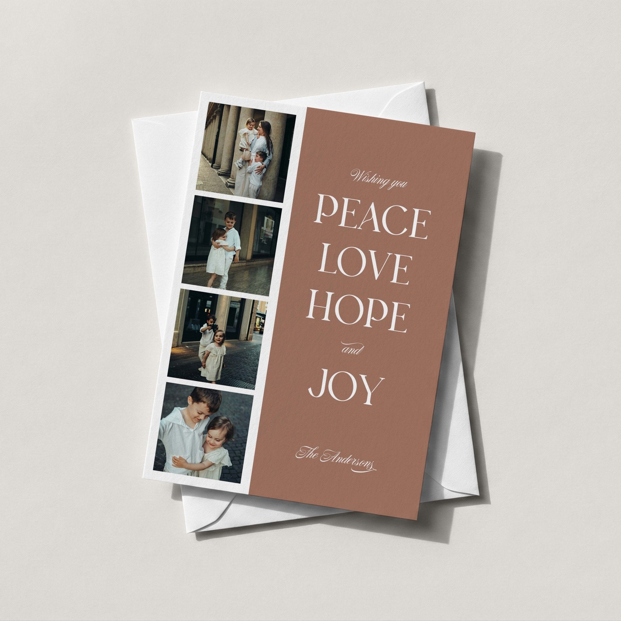 Photo Strip Holiday Card with four family photos and 'Peace, Love, Hope and Joy' in white serif type on a taupe background, styled with a white envelope