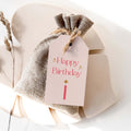 Pink Sparkle Birthday gift tag by Blú Rose, blush 'Happy Birthday' tag with pink lettering, gold sparkles, and a candle on a burlap favor bag