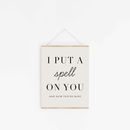 Put A Spell On You quote poster hanging from wood hanger with minimalist typography design