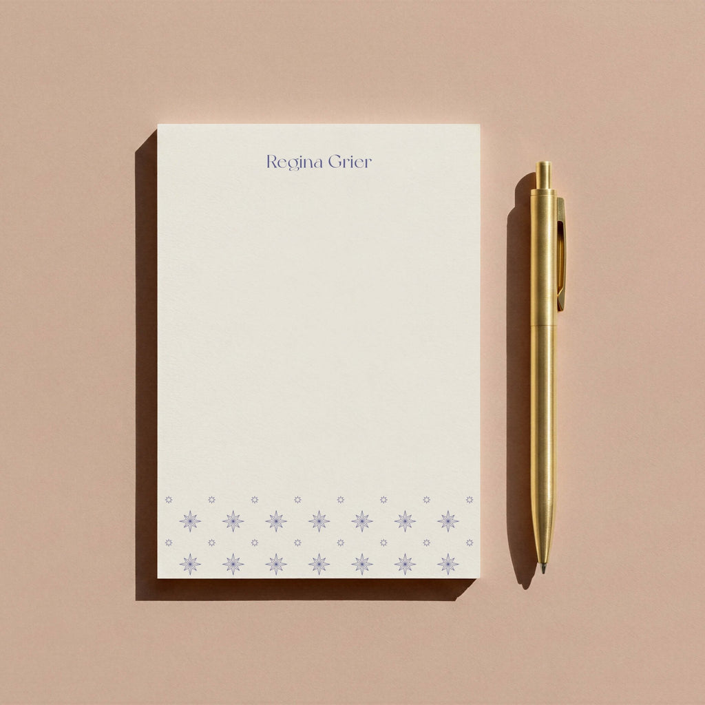 Regina Pattern personalized notepad by Blú Rose, periwinkle starburst notepad photographed with a gold pen on a mauve background