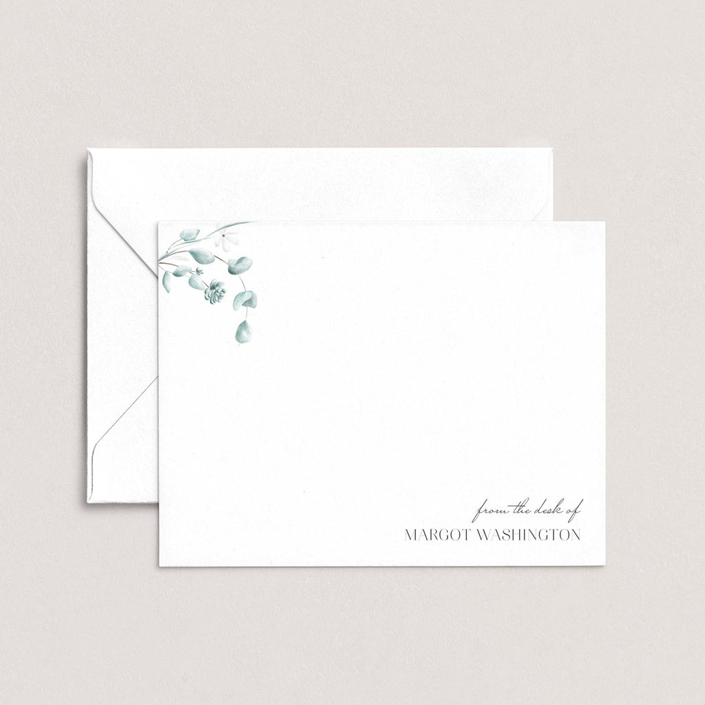 Simple Floral personalized notecards by Blú Rose, white flat notecard with delicate eucalyptus greenery and 'from the desk of Margot Washington', shown with a coordinating white envelope