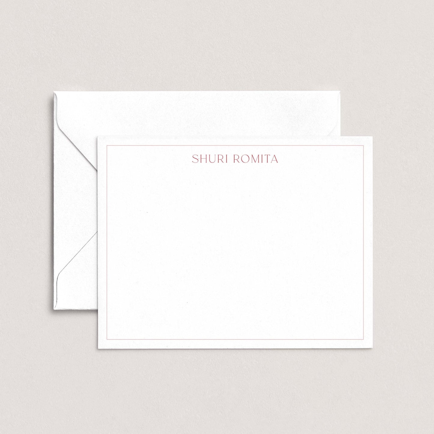 A white envelope with a blank card inside, both placed against a light background.