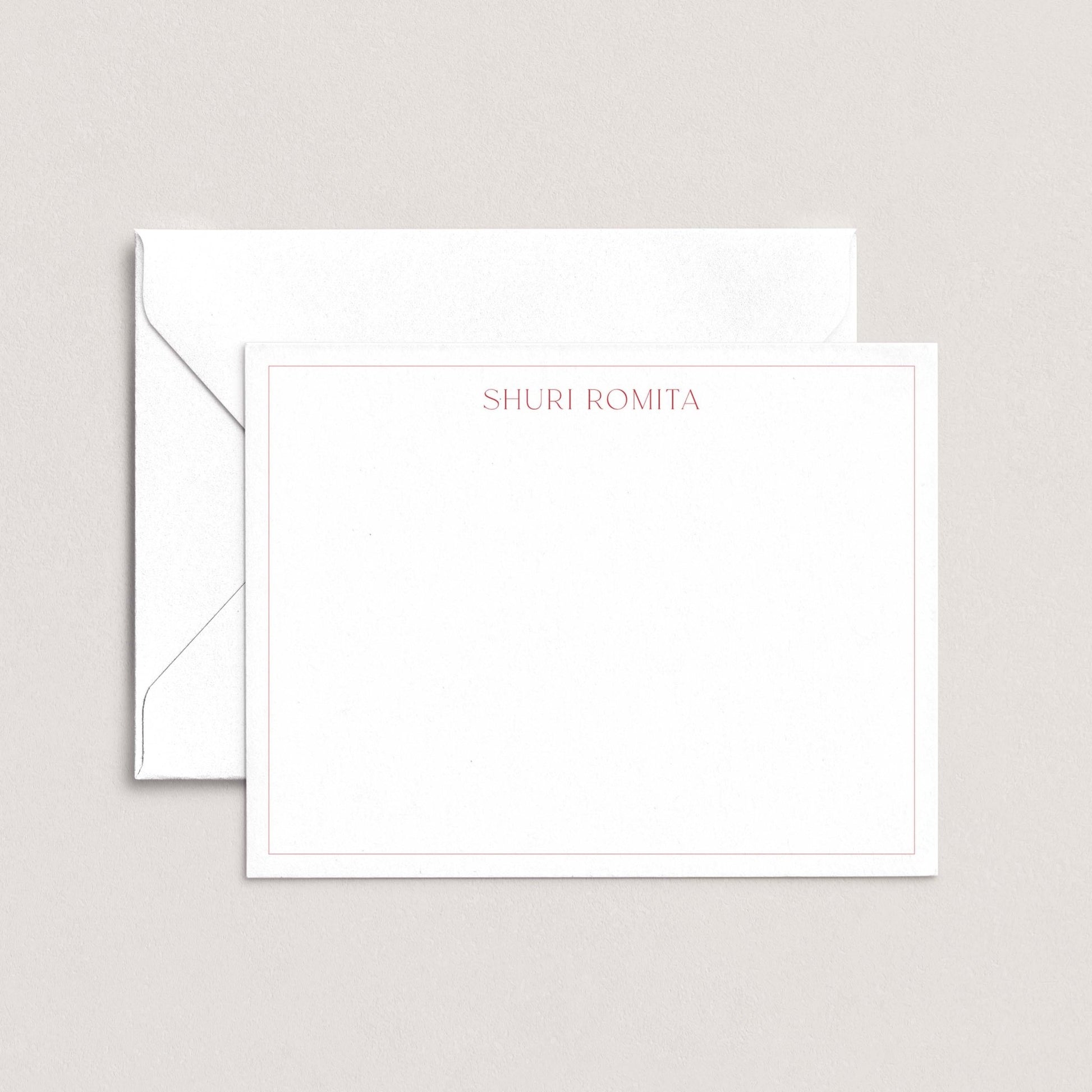 A white envelope with a blank card inside, both placed against a light background.