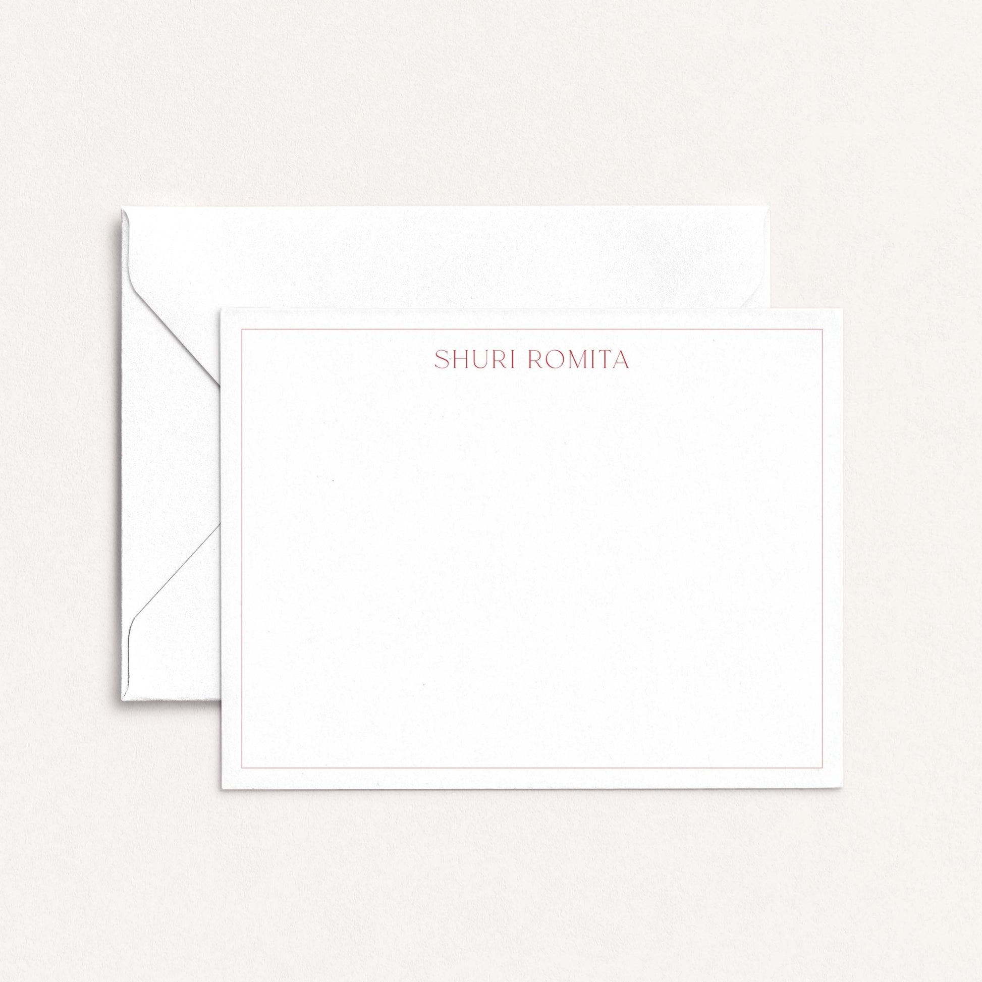 Personalized flat notecard with Ironroot red border and name in serif font, shown with matching envelope on neutral background.