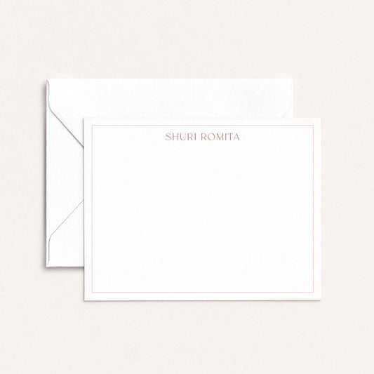 Personalized flat notecard with Ironroot red border and name in serif font, shown with matching envelope on neutral background.