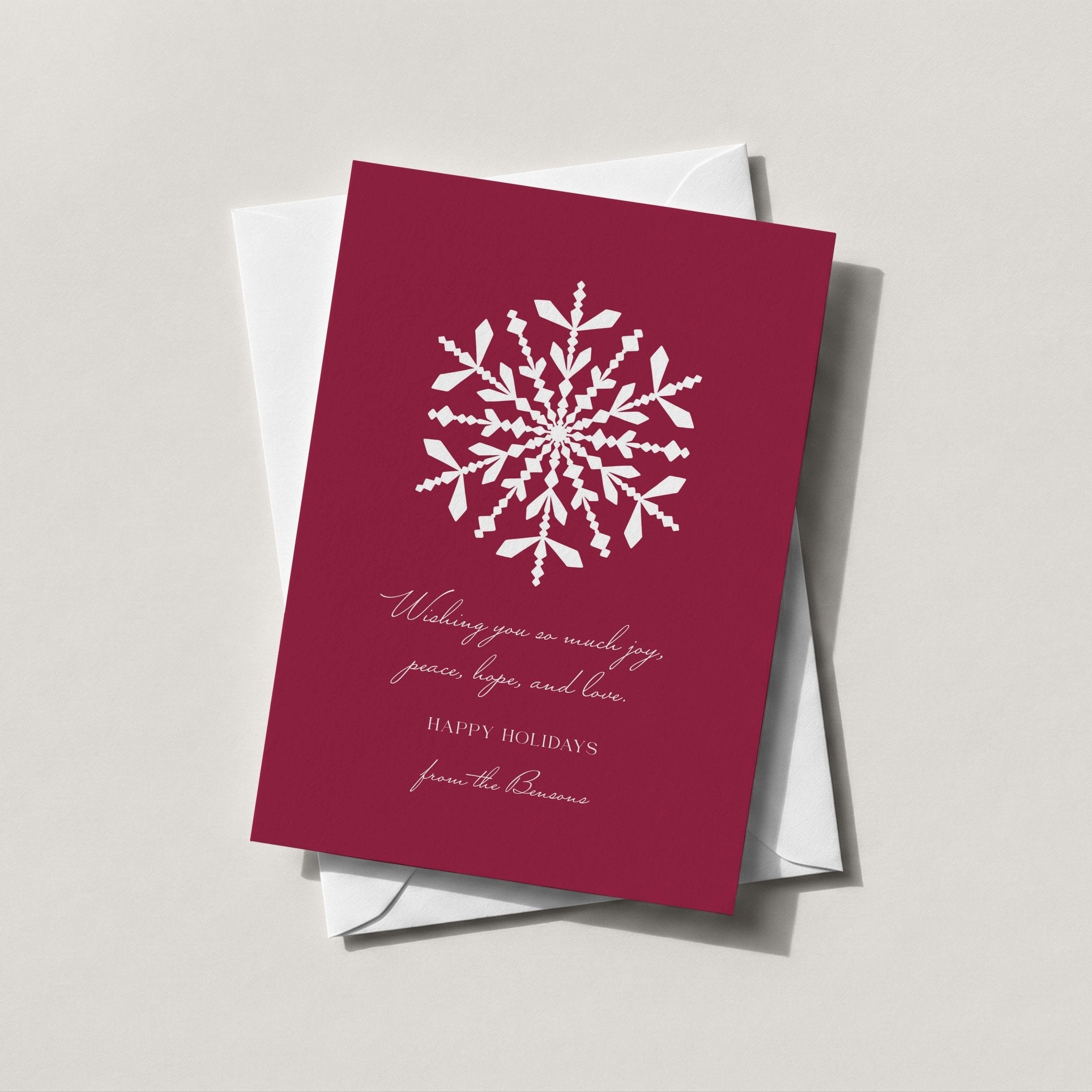 Snowflake holiday card in deep burgundy with a large hand-drawn white snowflake