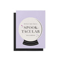 Spooktacular Halloween greeting card with witchy crystal ball design on lavender background paired with black envelope.