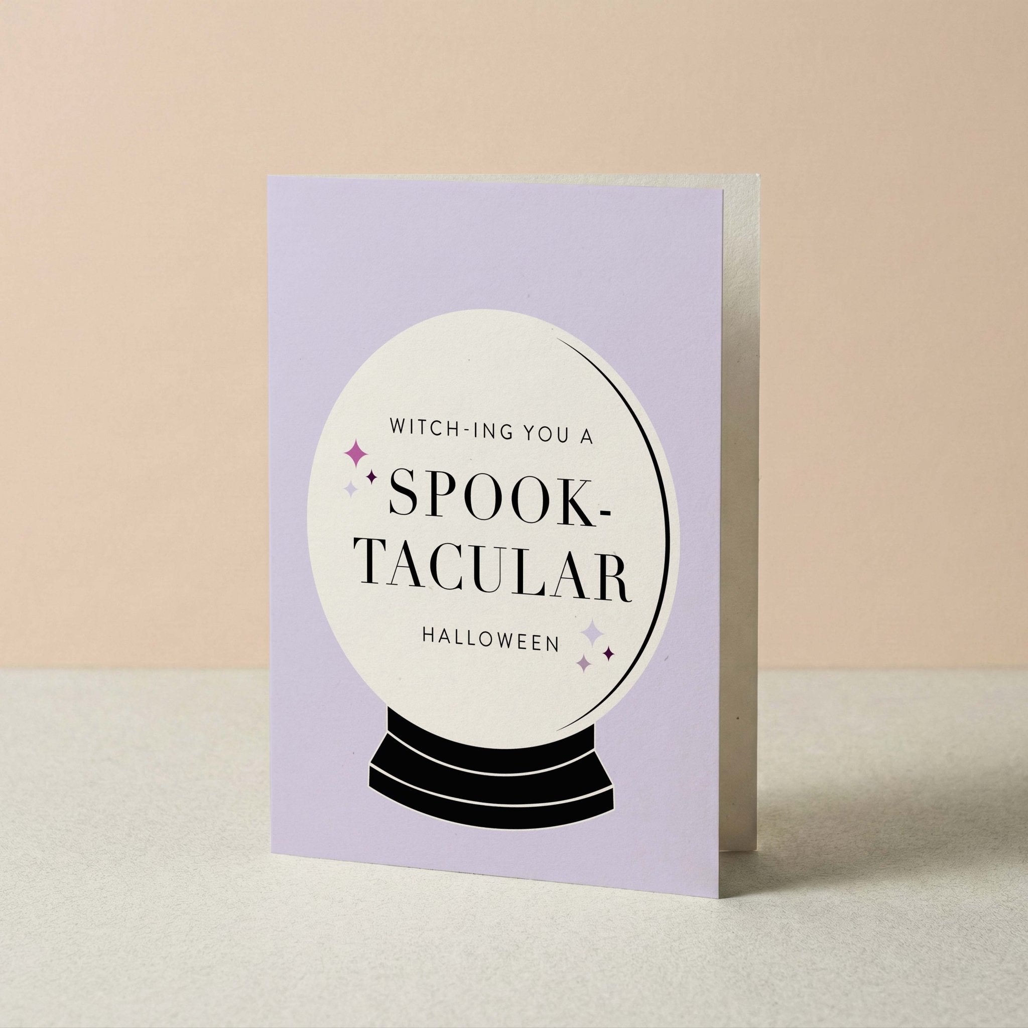 Spooktacular Halloween card by Blú Rose standing upright, lavender card with crystal ball illustration on a neutral background