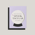 Spooktacular Halloween greeting card by Blú Rose, lavender card with crystal ball illustration and witch-ing you a spooktacular Halloween text, shown with black envelope