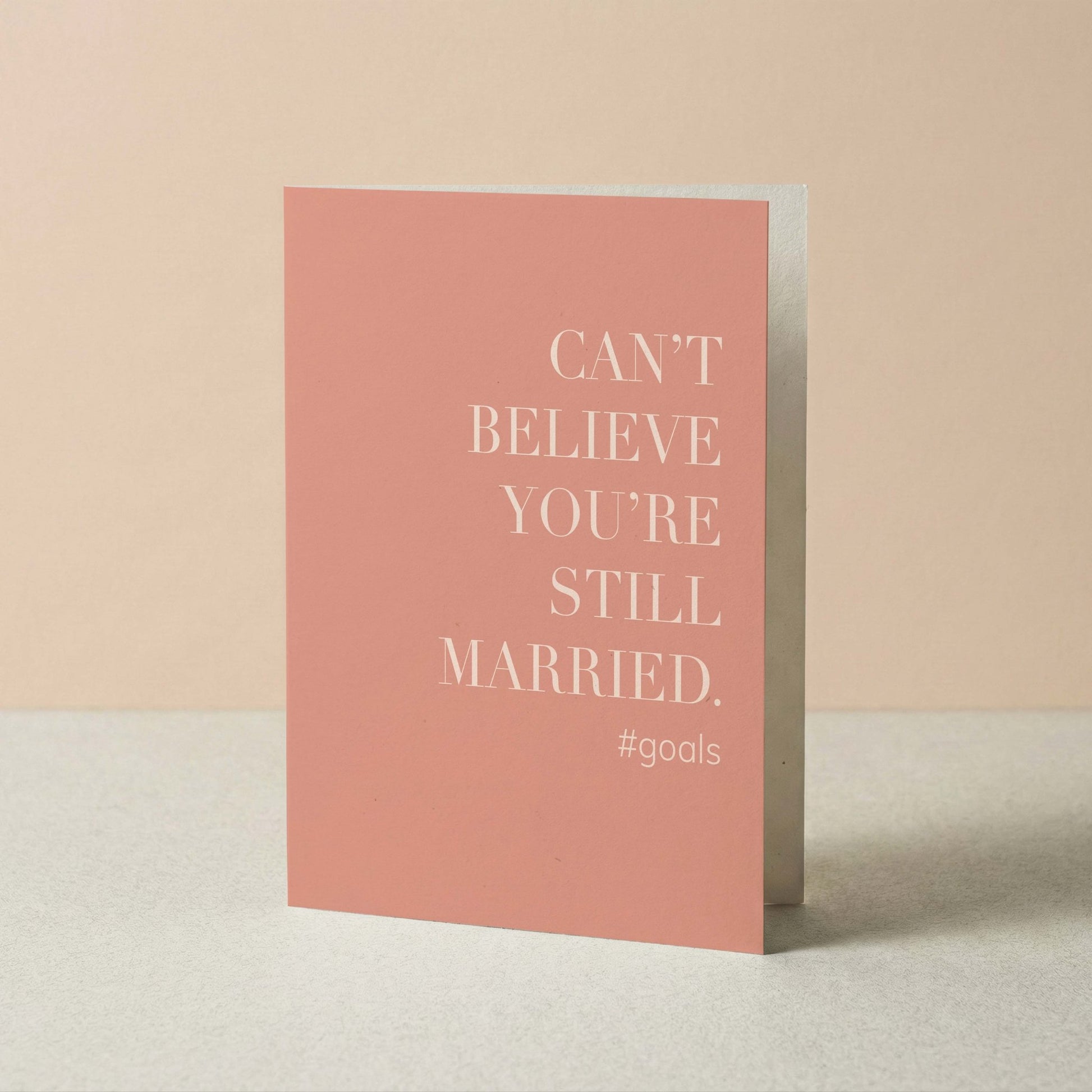 Pink card with white text on a beige background