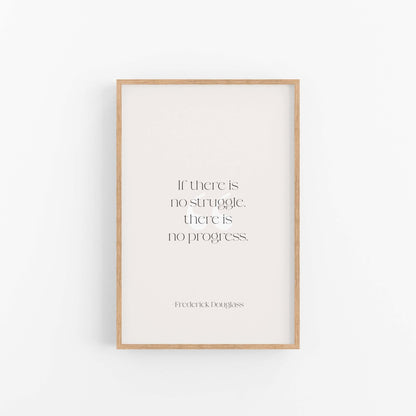 Light wood framed Frederick Douglass quote print centered on clean white wall