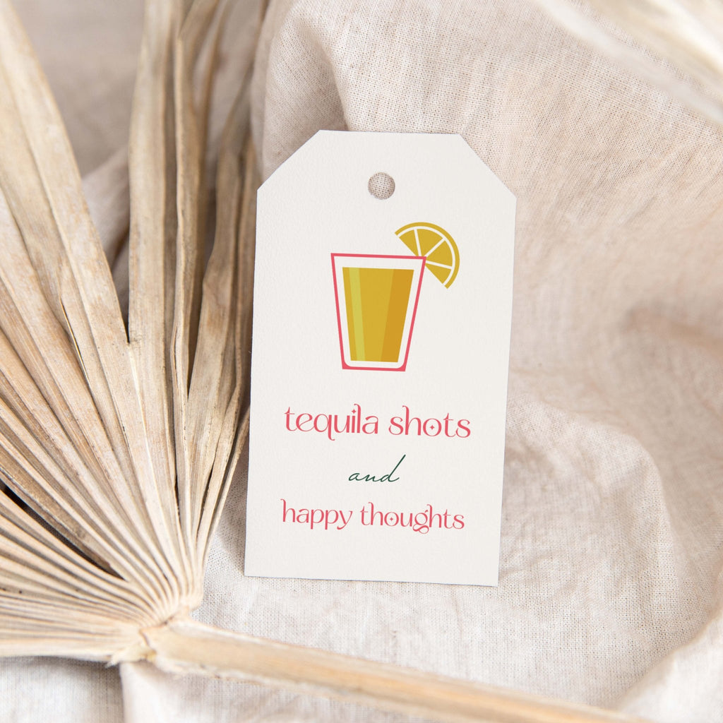Tequila Shots gift tags by Blú Rose, white 'tequila shots and happy thoughts' tag with a shot glass and lime styled on a dried palm leaf