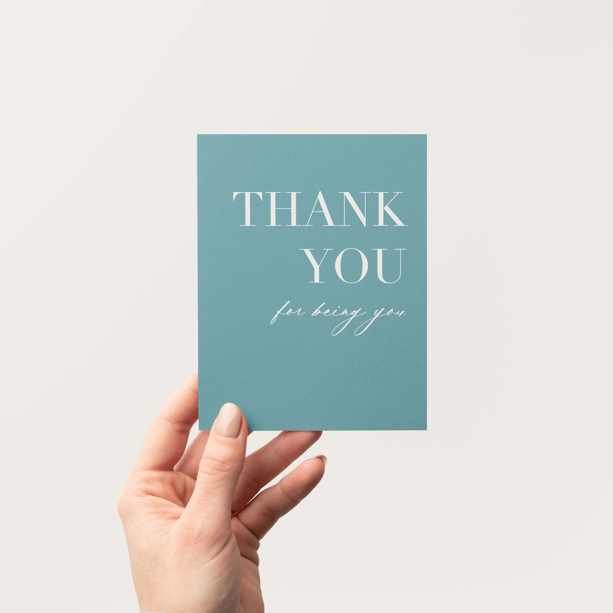 Thank You for Being You greeting card by Blú Rose held in hand against a neutral off-white background