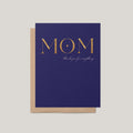 A navy blue greeting card with metallic gold lettering that reads 'MOM' and 'thank you for everything' in cursive, shown with a kraft paper envelope on a light gray background.