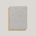 The Labyrinth greeting card by Blú Rose, ivory card with bold black geometric maze pattern, shown with kraft envelope