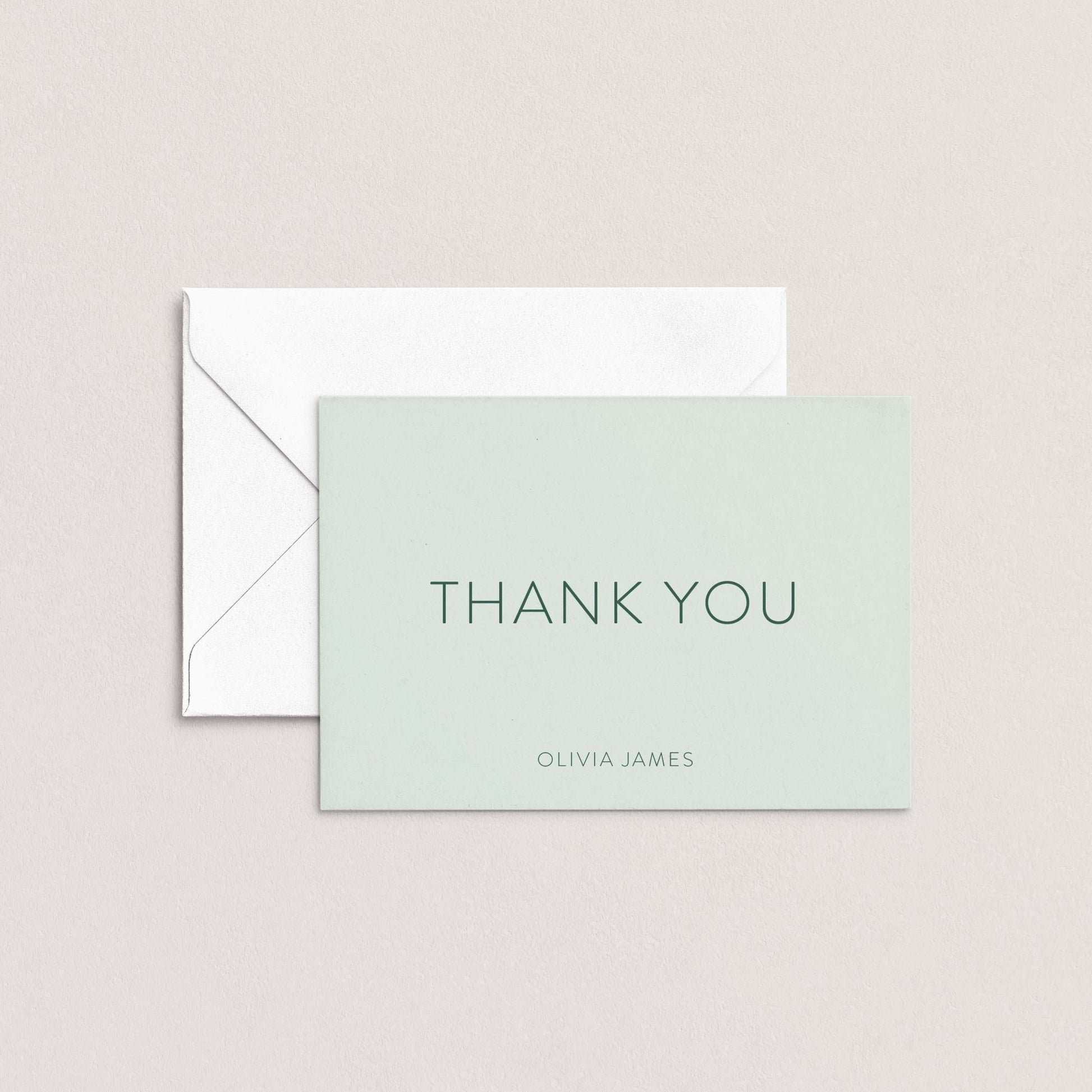 The Olivia personalized thank you card by Blú Rose in sage green with dark green text shown flat with white envelope on a neutral background