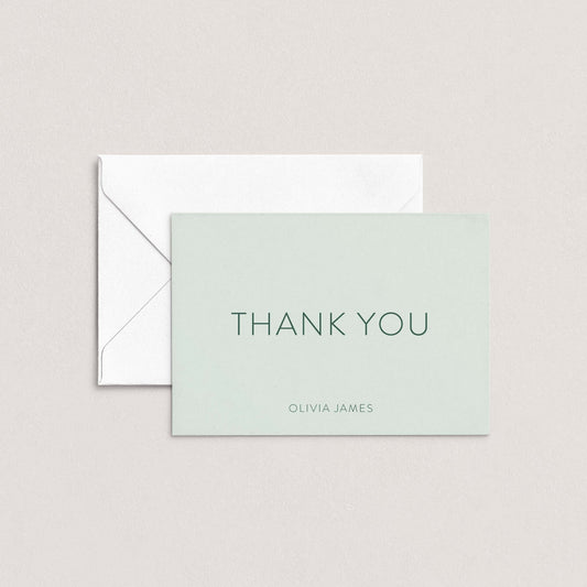 The Olivia personalized thank you card by Blú Rose in sage green with dark green text shown flat with white envelope on a neutral background