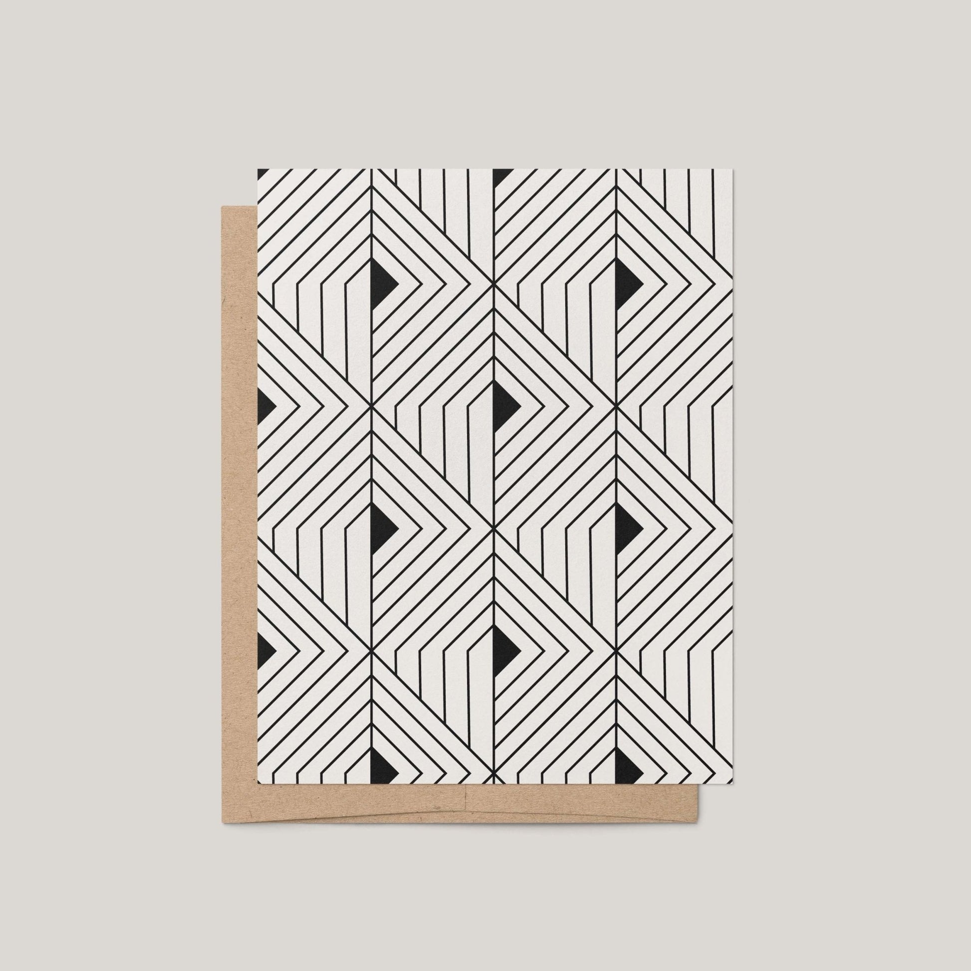 The Prism Greeting Card by Blú Rose featuring a bold black and off-white geometric angular pattern shown with a kraft envelope on a gray background